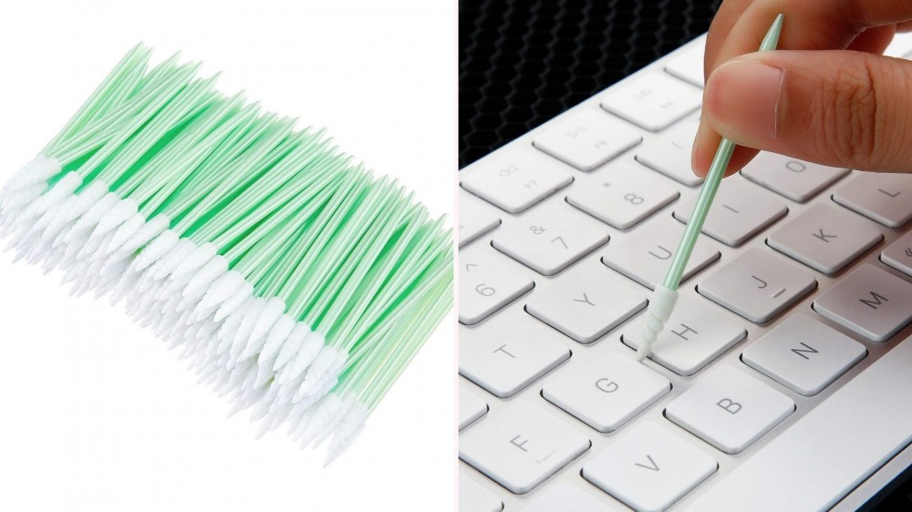 Swabs being used to clean computer keyboard.