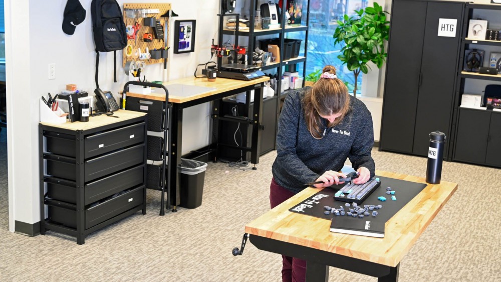 Person measuring keys on a disassembled mechanical keyboard